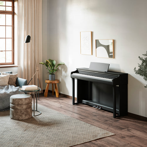 A Yamaha Clavinova CLP-825 Digital Piano - Matte Black in a stylish living room