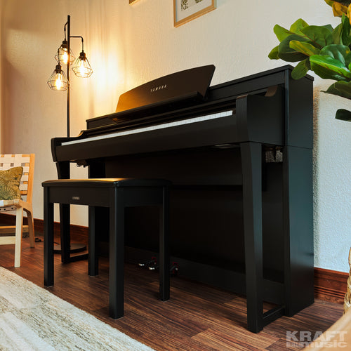 Yamaha Clavinova CSP-275 Digital Piano - Black Walnut - in a stylish living room facing left