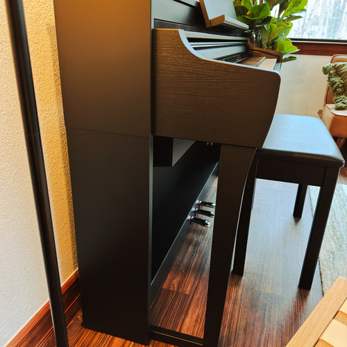 Yamaha Clavinova CSP-275 Digital Piano - Black Walnut - in a stylish living room side view