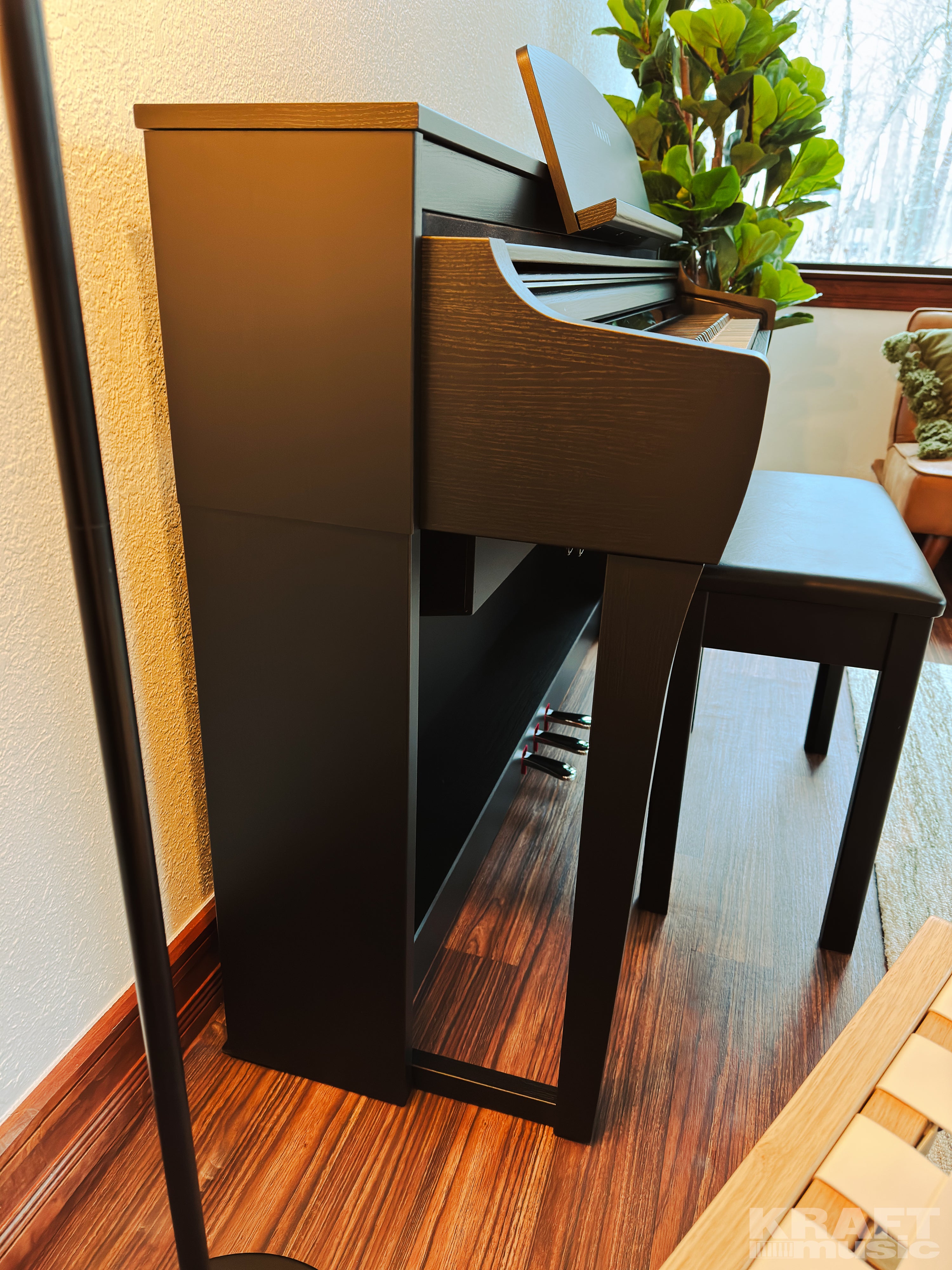 Yamaha Clavinova CSP-275 Digital Piano - Black Walnut - in a stylish living room side view