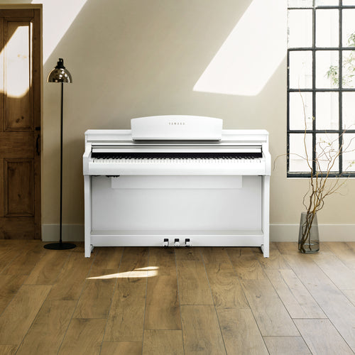 Yamaha Clavinova CSP-275 Digital Piano - Matte White - front view in a stylish living space