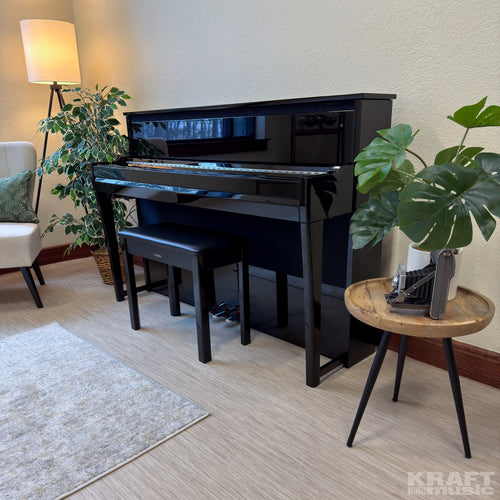 Yamaha AvantGrand NU1XA Hybrid Piano - Polished Ebony - left facing in a stylish living space with key cover closed