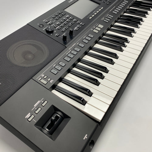 Digital keyboard with black keys and gray body on a light gray background