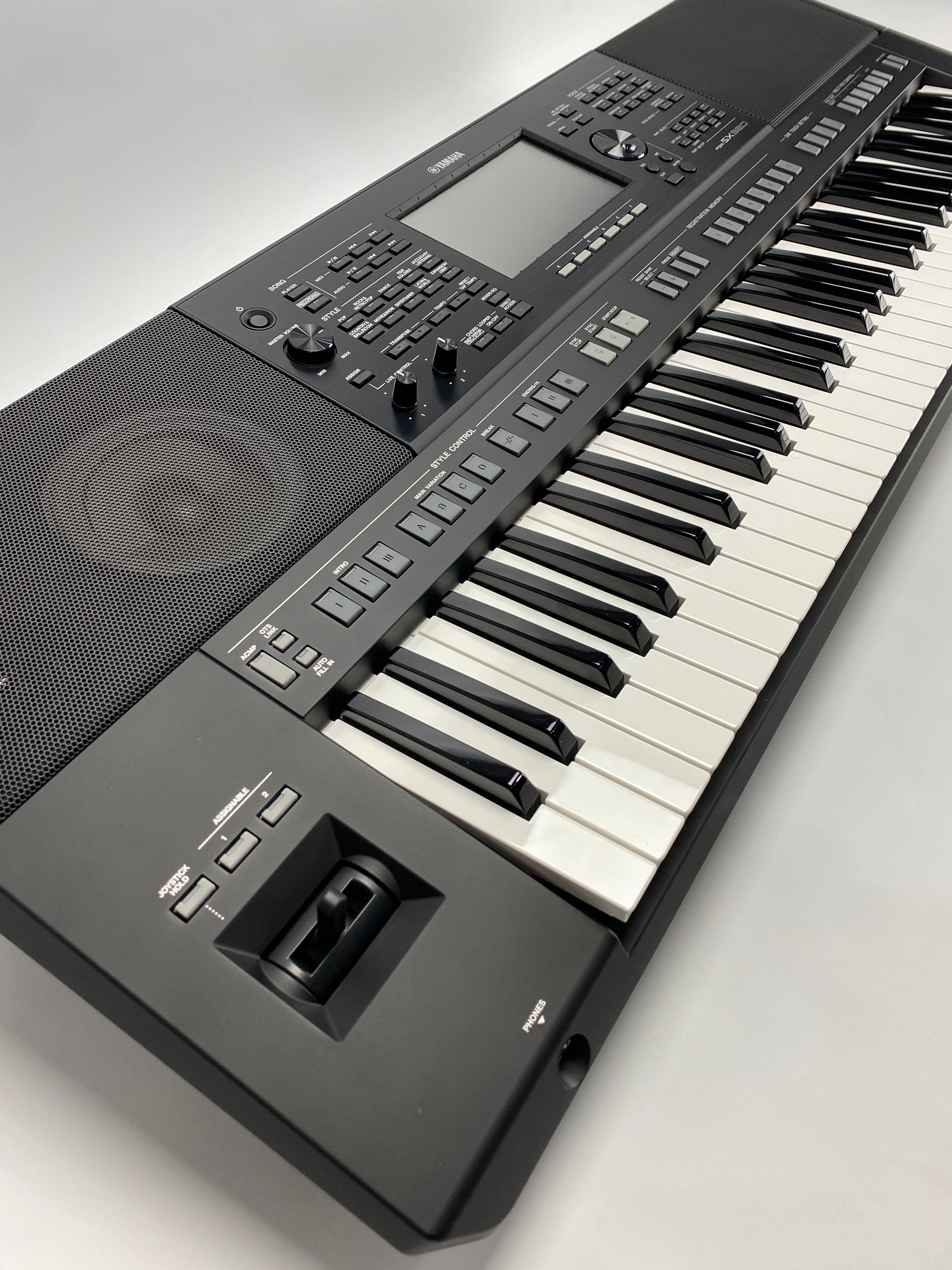 Digital keyboard with black keys and gray body on a light gray background