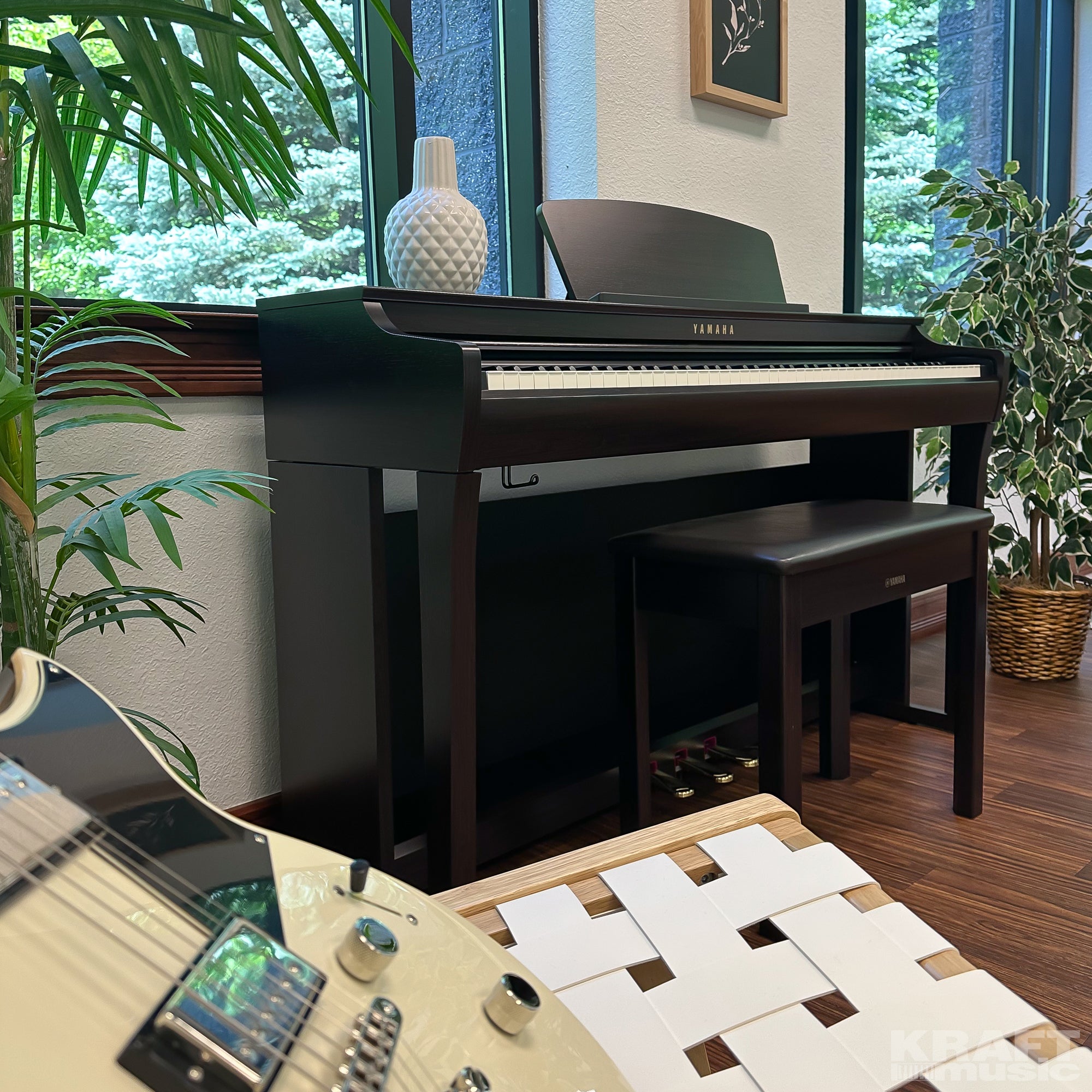Yamaha Clavinova CLP-725 Digital Piano - Rosewood - right facing with a Revstar guitar in the foreground
