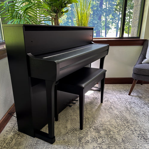 Yamaha Clavinova CLP-885 Digital Piano - Matte Black in a stylish room, with key cover closed