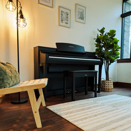 Yamaha Clavinova CSP-275 Digital Piano - Black Walnut - in a stylish living room facing the right