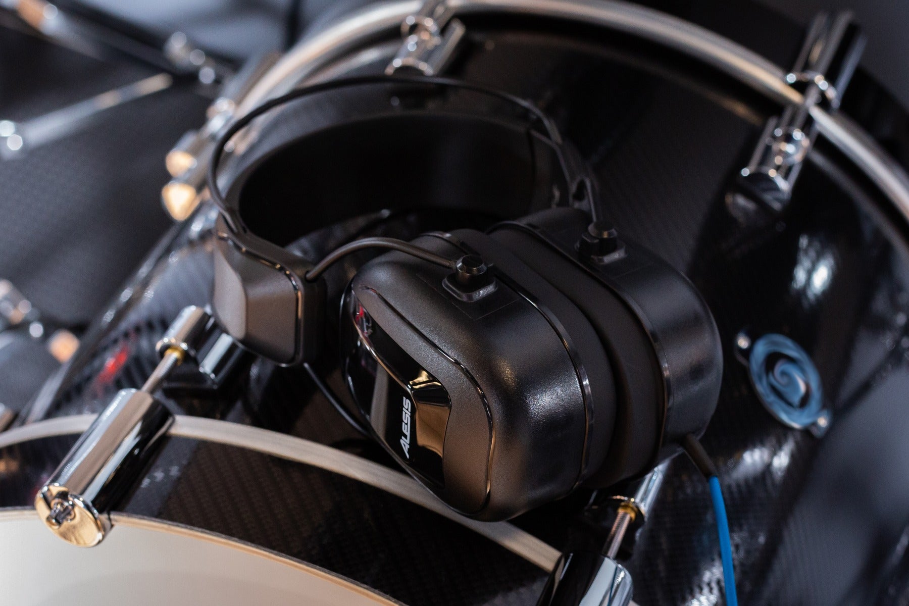 View of the Alesis DRP100 Electronic Drum Reference Headphones on top of an electronic bass drum