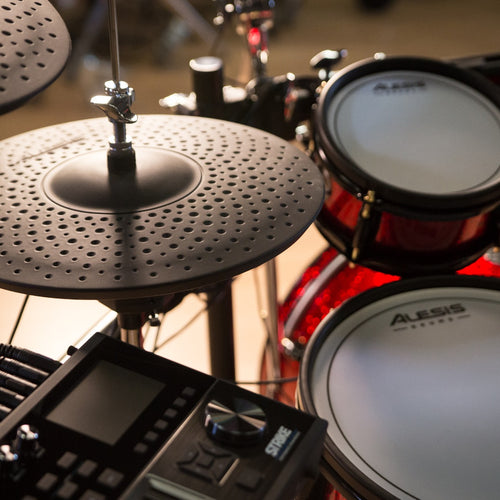 Close shot of a hi-hat cymbal, snare, toms and the module for the strike pro se drum set