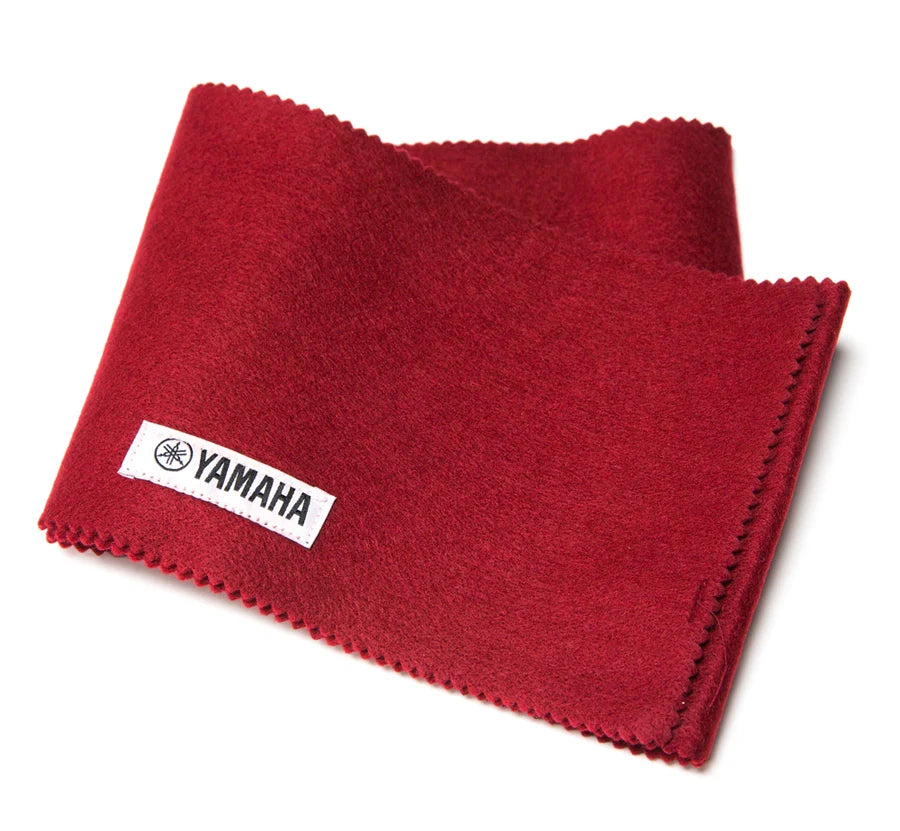 Folded red Yamaha felt key cover with pinked edges and a sewn-in white Yamaha logo tag, on a white background.