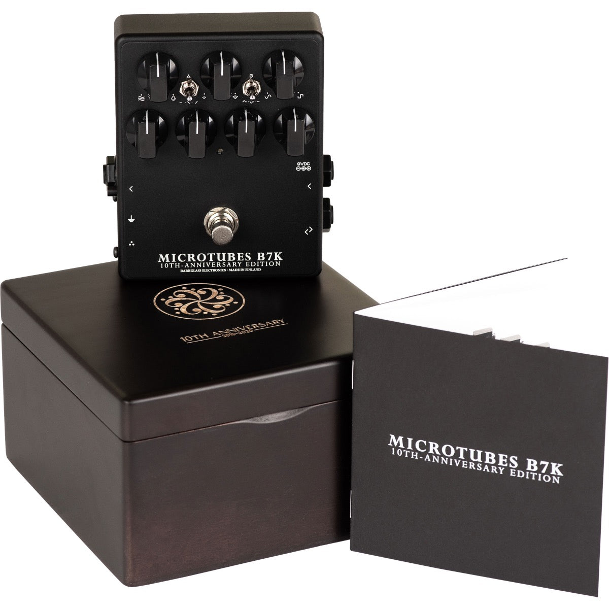 3/4 view of Darkglass Microtubes B7K 10th Anniversary pedal, commemorative box and booklet