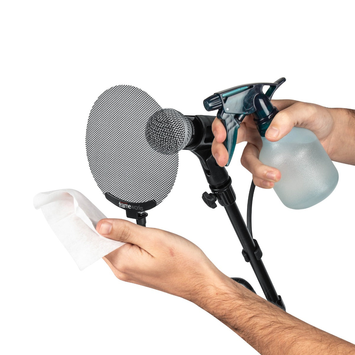 Human hands holding spray bottle and cloth preparing to clean the pop filter