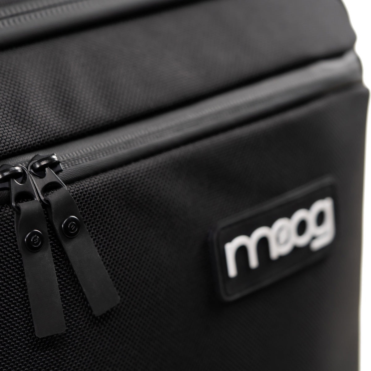 Detail image of Moog Grandmother SR Case showing zipper construction and Moog logo badge