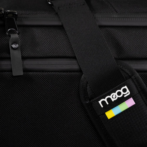 Detail image of Moog Matriarch SR Case showing shoulder strap with Moog logo badge