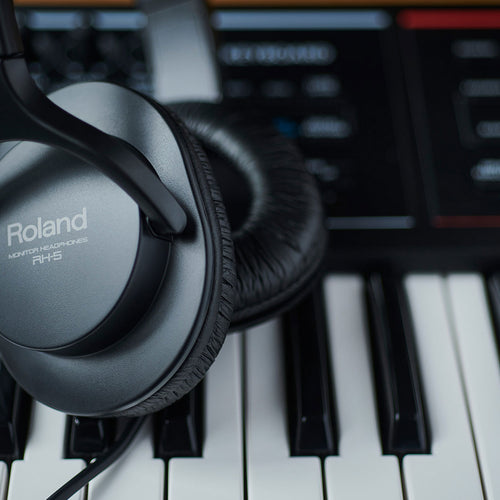 Lifestyle image of the Roland RH-5 Stereo Headphones - Black, laying over a keybed
