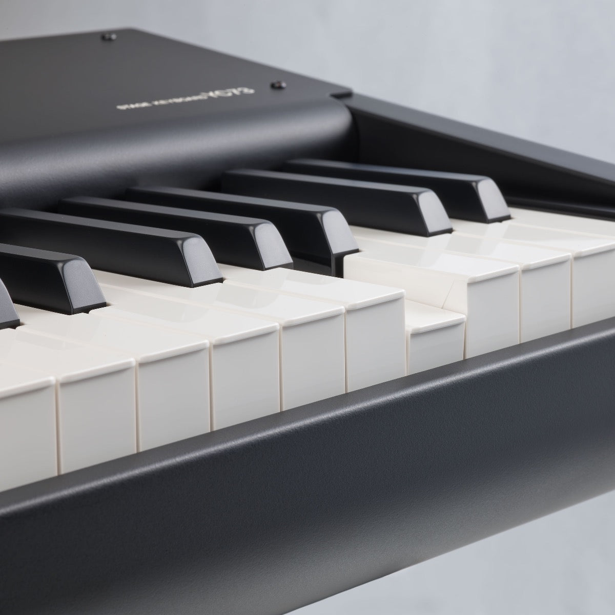 Detail view of Yamaha YC73 73-Key Stage Keyboard and Organ showing portion of keybed with one key depressed