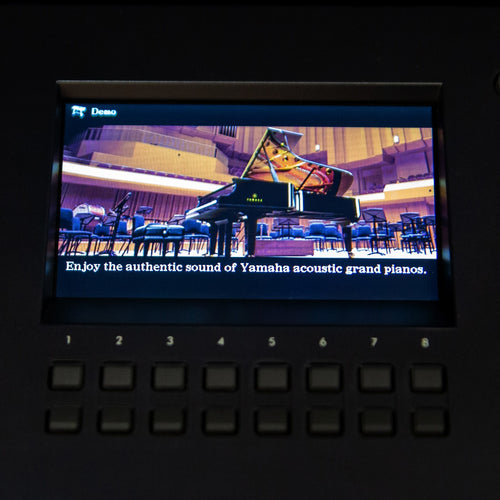 Close up of the Yamaha DGX-670 control panel showing the acoustic piano option on the screen